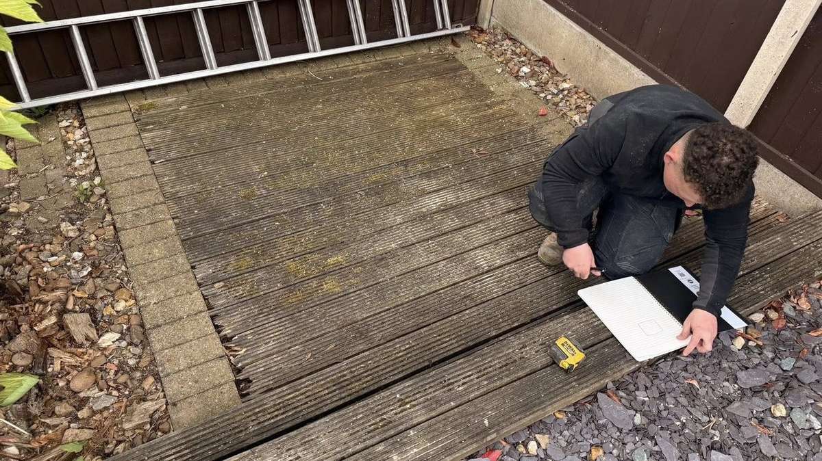 Tyler discussing a garden project with a customer