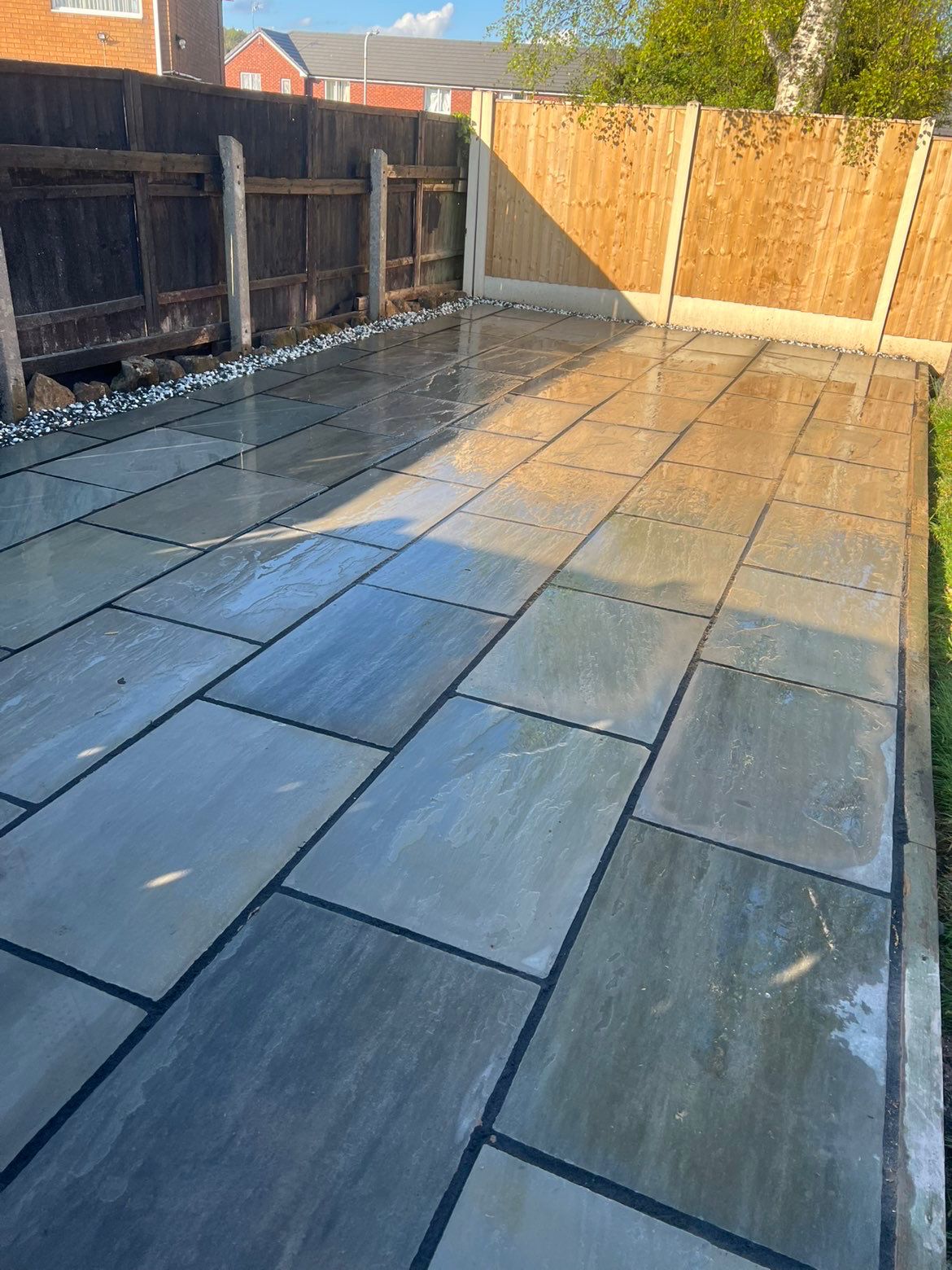 Slate patio slabbing in a back garden completed by TMH Quality Construction